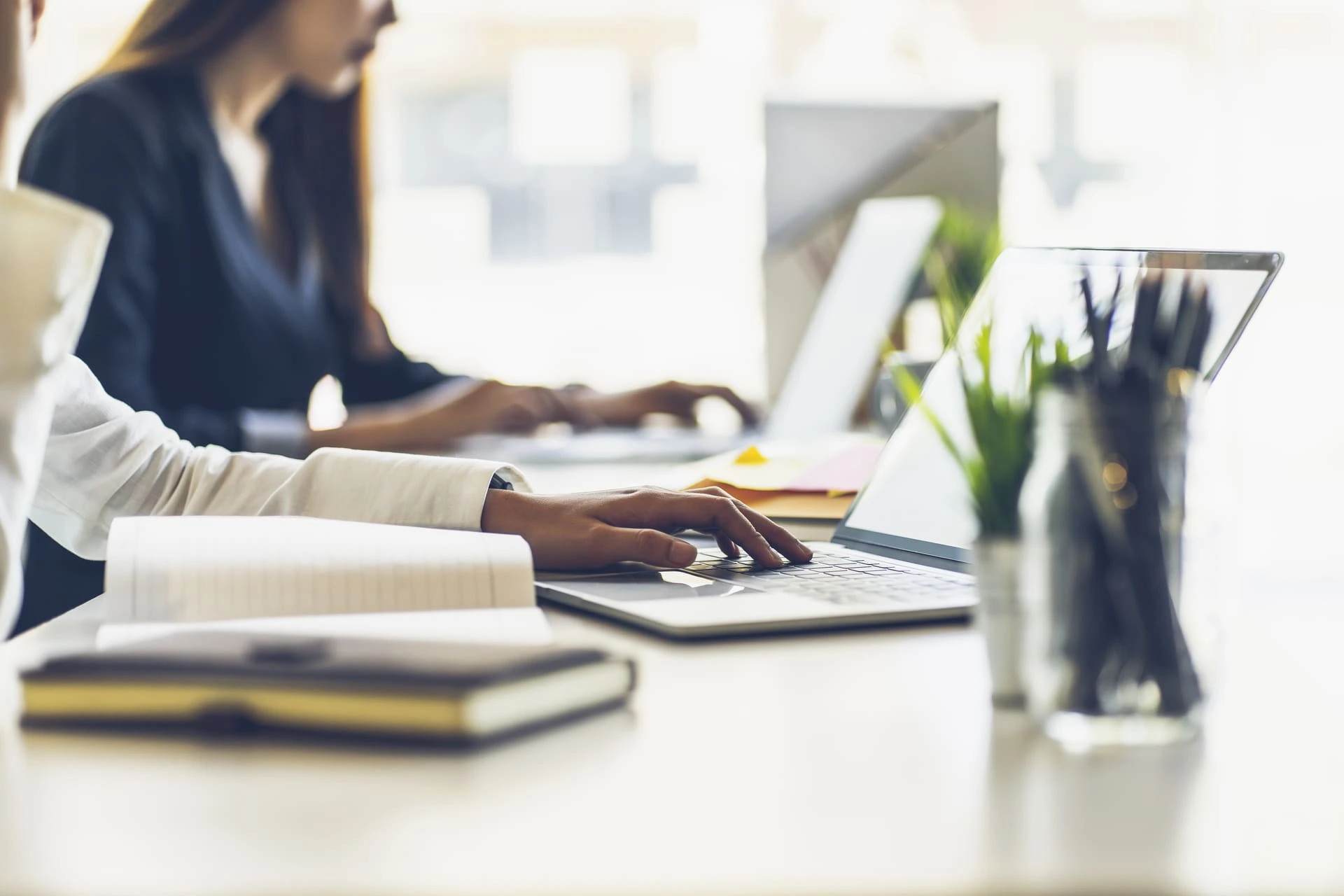 Deux personnes qui travaillent sur des ordinateurs dans un bureau
